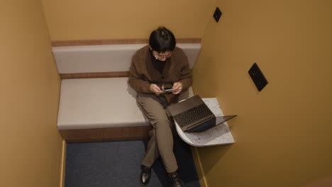 person working in a small office pod