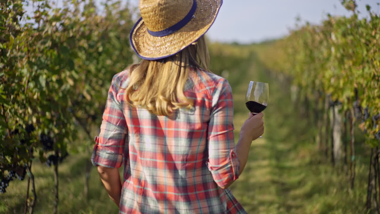 Woman enjoying wine in vineyard