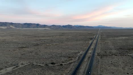 Highway-93-in-Arizona-with-desert-landscape-and-mountains-in-the-distance-with-drone-video-stable