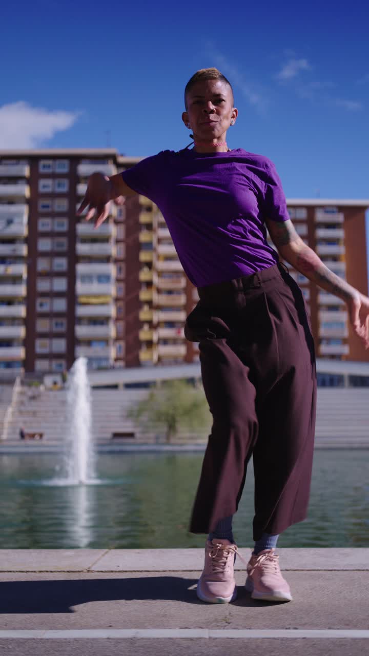 Energetic Woman Dancing Hip Hop in an Urban Park by a Lake