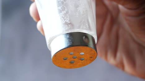 Close-up-of-salt-pouring-on-table