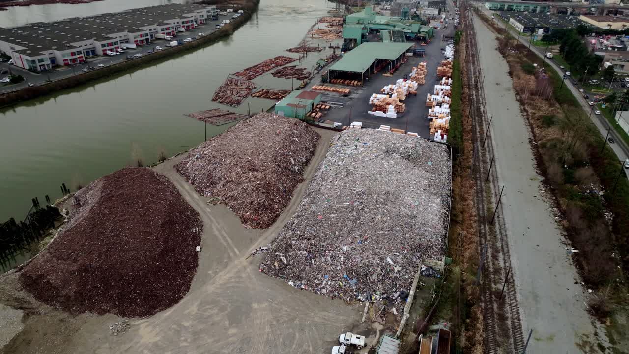 Recycling Transfer Station Along The Fraser River In Vancouver, British Columbia, Canada. - aerial shot