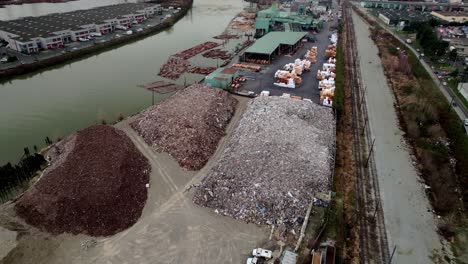 recycling transfer station along the fraser river in vancouver, british columbia, canada. - aerial shot