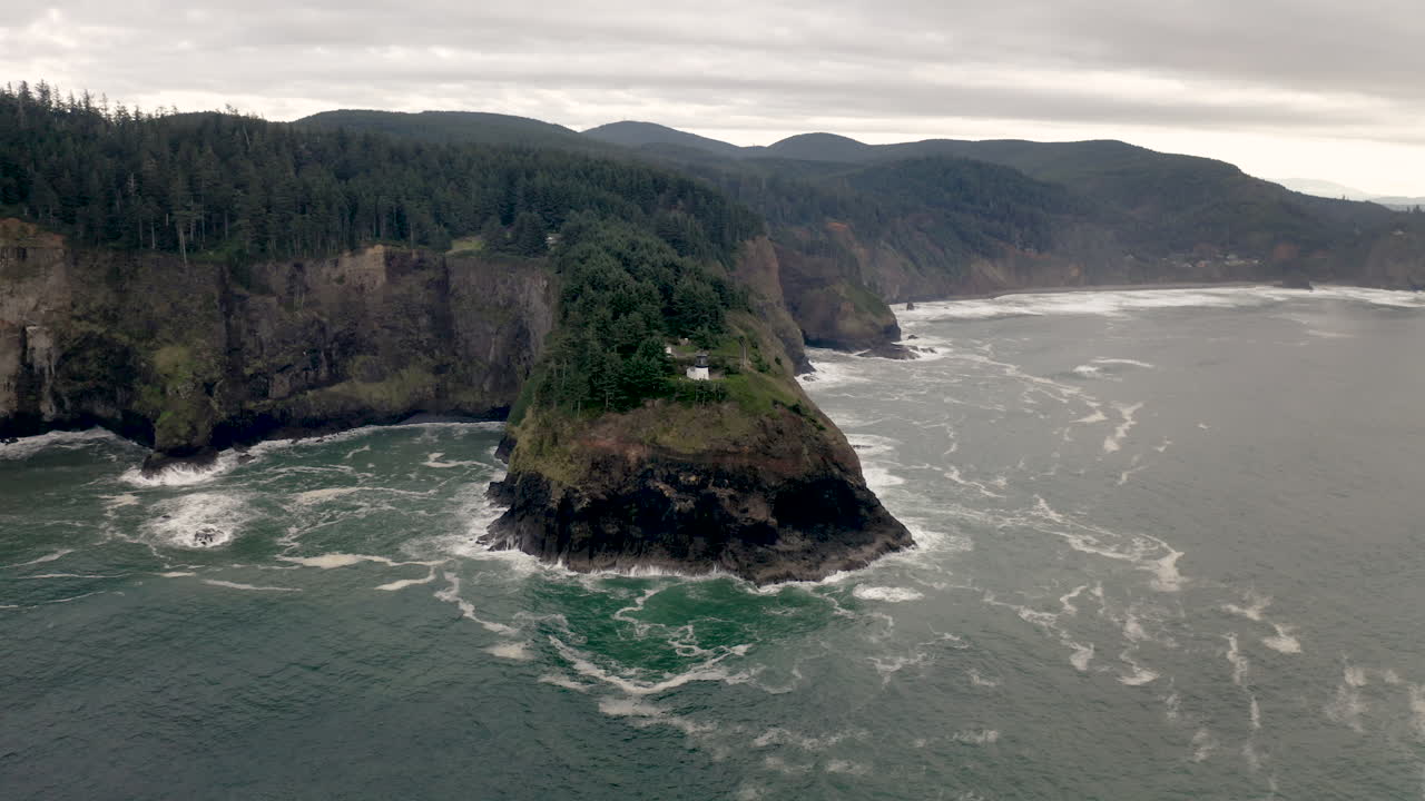 Heceta Head Lighthouse on a rugged Oregon coast with crashing waves