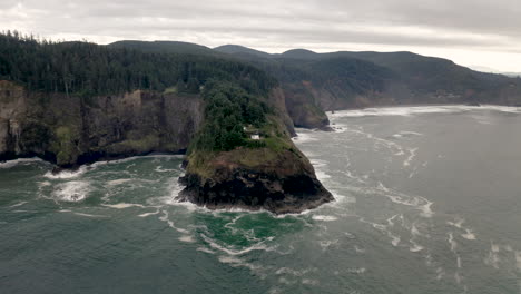 heceta head lighthouse on a rugged oregon coast with crashing waves