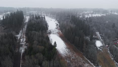 drone flyover ski resort winter with little snow, global warming scene