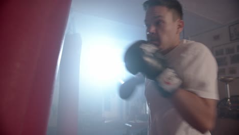 a boxer trains in a training room with a punching bag