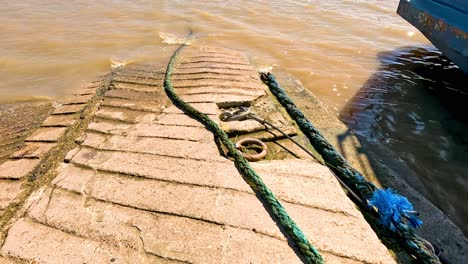 a boat approaches and docks at the pier