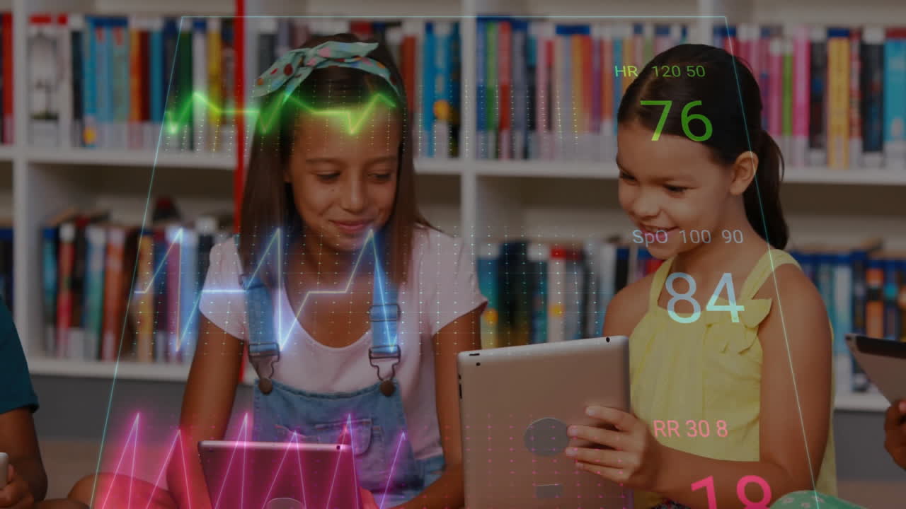 Girls using tablets in library for health education, showing animated HR SpO2 RR waveform graphs
