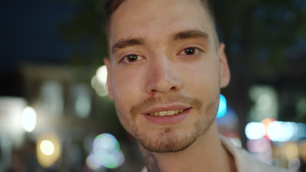 Man Smiling in City at Night