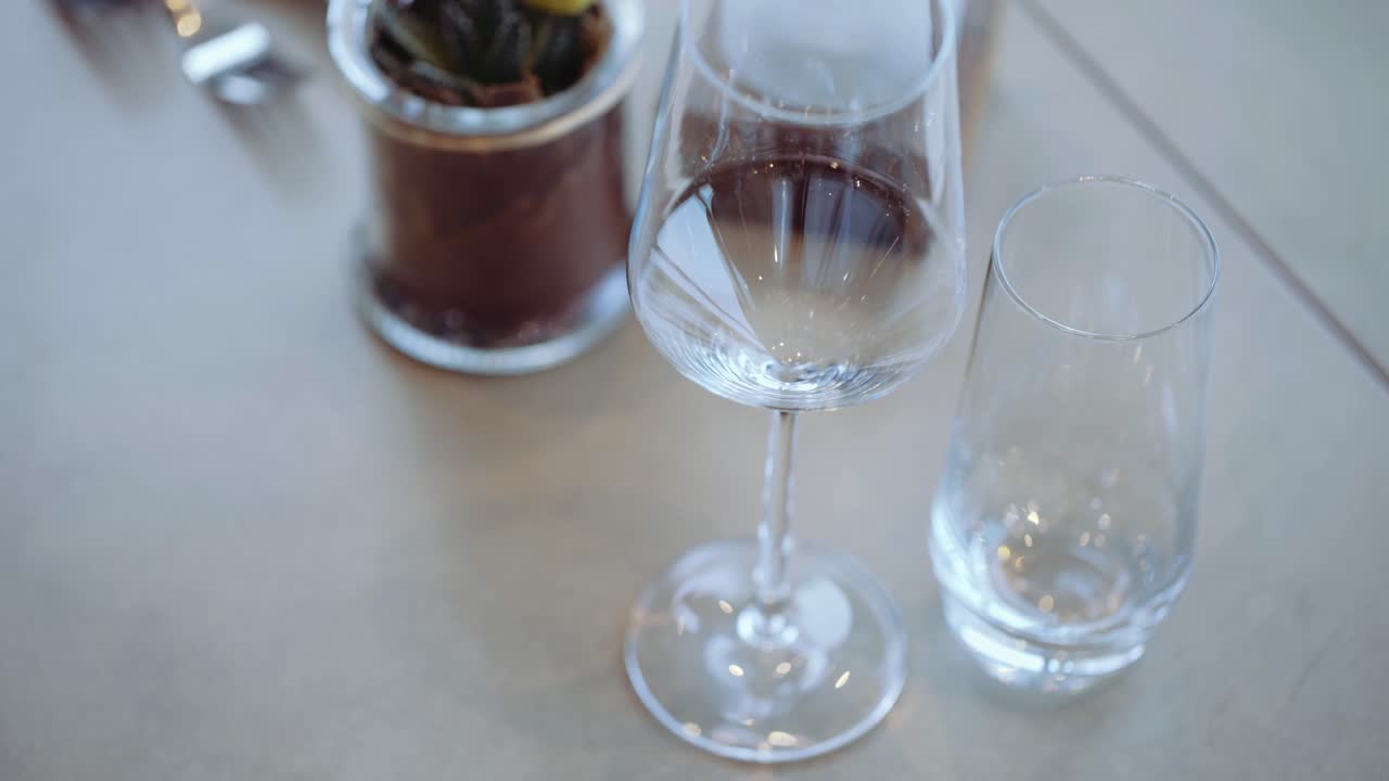 CLOSE UP : Wine glass being put on a table. Decorating dinner table