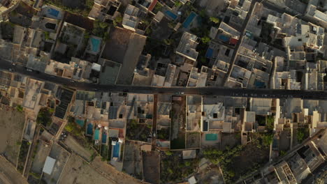 Road-in-Mediterranean-Small-Town-City-with-no-traffic-during-Coronavirus-Covid-19-Pandemic-Lockdown,-Brown-and-Beige-Sand-Colored-Houses,-Aerial-Birds-Eye-Overhead-Top-Down-View