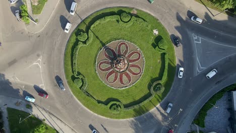 4k aerial view of roundabout road with circular cars in small european city at sunny day