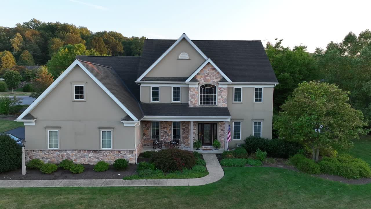 Large home with American flag during summer sunset