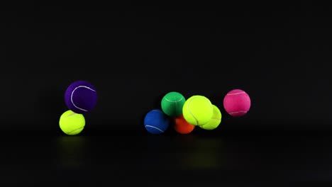 vibrant tennis balls bouncing against a dark background