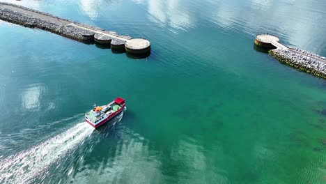 Drone-car-ferry-sailing-out-of-harbour-in-Castletownbere-West-Cork-Ireland-on-a-bright-sunny-summer-morning