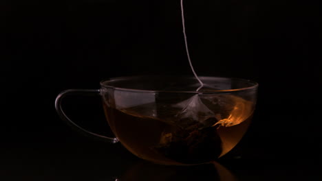 Teabag-dunking-into-glass-cup