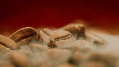 close up of seeds of coffee. fragrant coffee beans are roasted smoke comes from coffee beans.