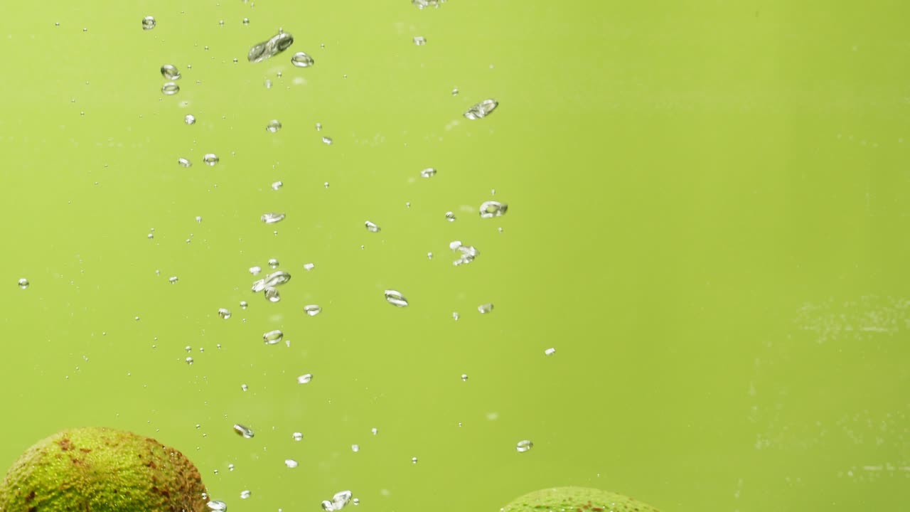 Limes in Water with Bubbles