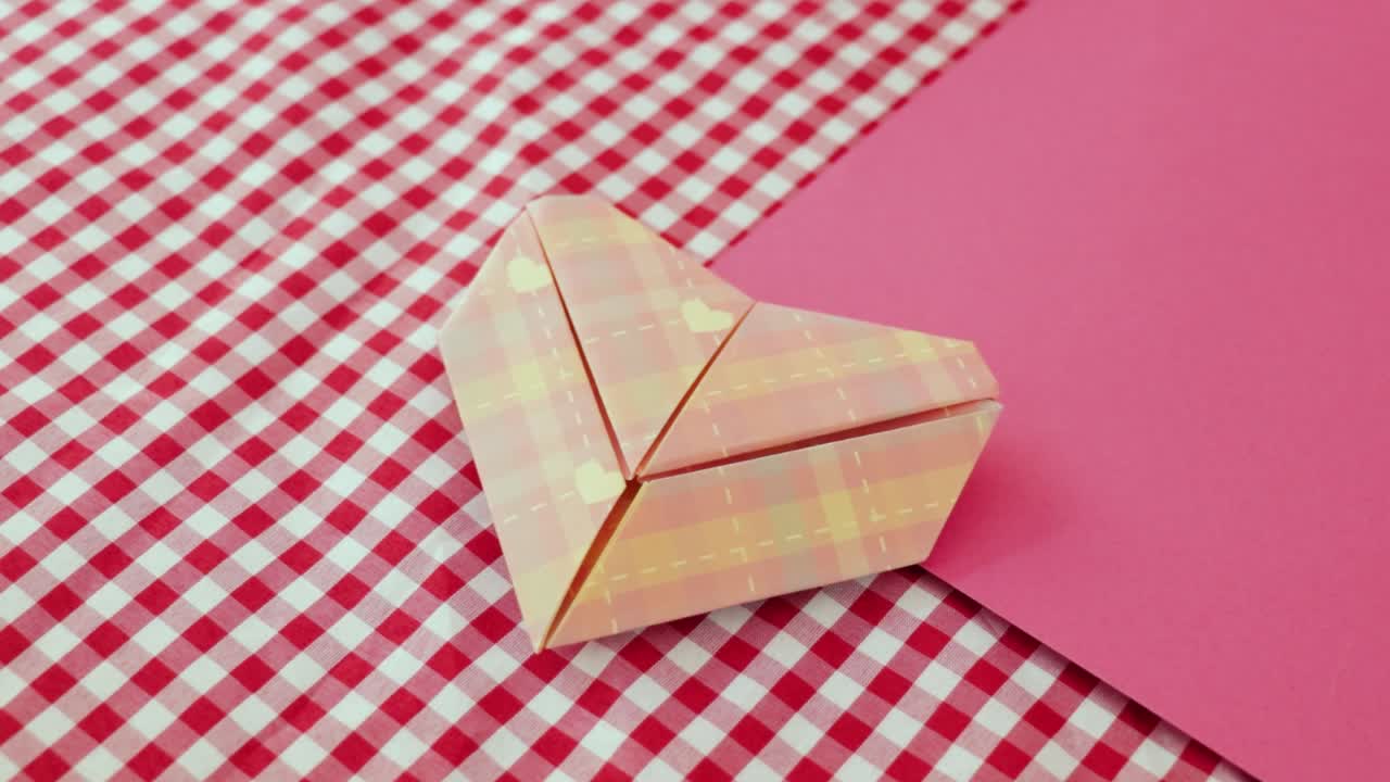 정교하게 접힌 오리가미 심장은 아름답게 디자인 된 종이로 만들어졌습니다.