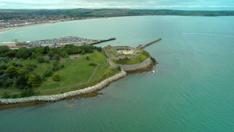 nothe fort on the mouth to weymouth harbour, england - aerial drone shot