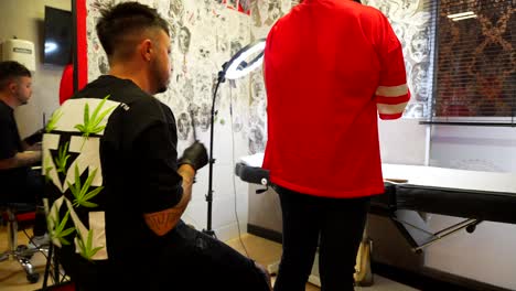 tattoo artist at work in studio