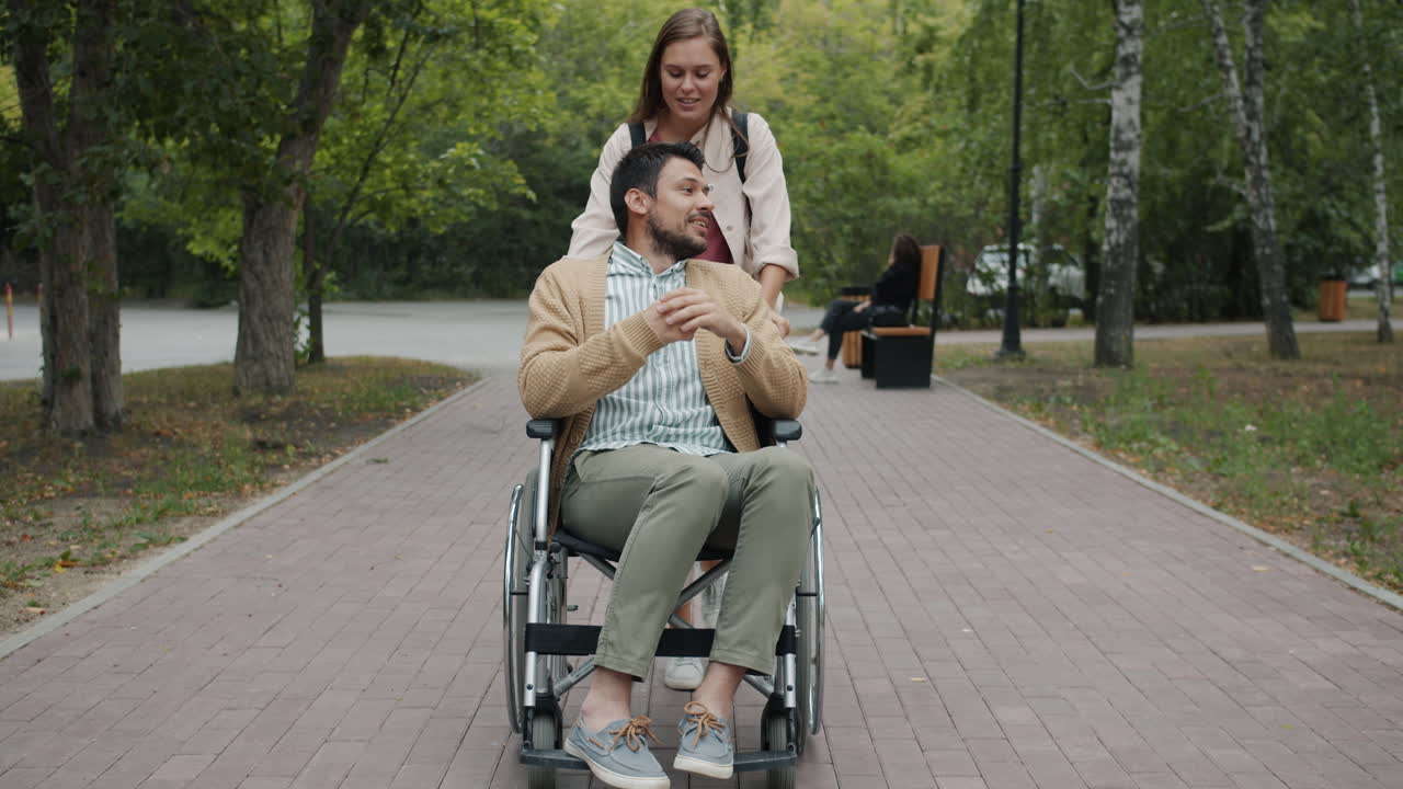 Couple in a Park with Person in Wheelchair
