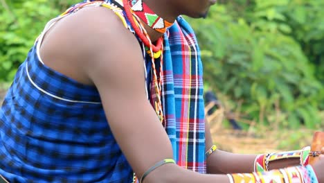 Masai-cultural-male-working-with-his-traditional-attire-on