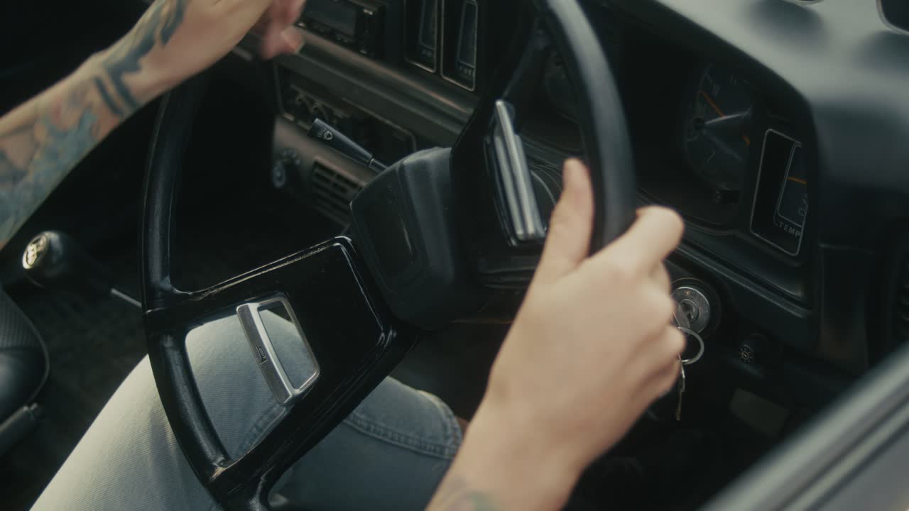 Woman Starting a Vintage Car