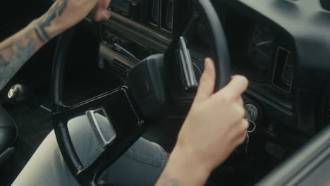 woman starting a vintage car