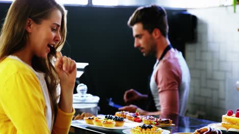 Customer-selecting-dessert-at-counter