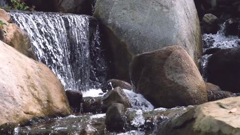 waterfall crashes down and splashes droplets in 10x slow motion