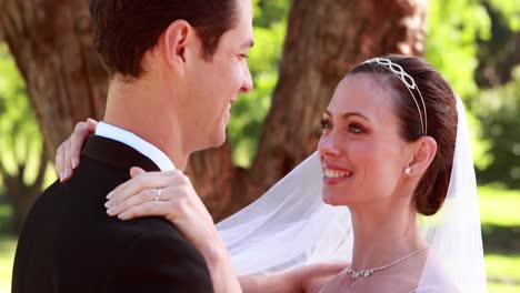 Young-newlyweds-dancing-together-and-smiling-