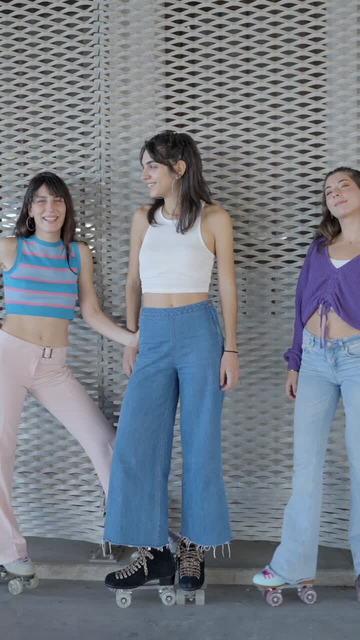 Three friends posing on roller skates