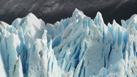 The-spiked-tops-of-a-glacier-stand-against-rugged-mountains-3