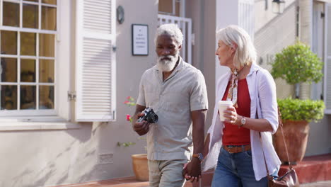 senior couple walking and holding hands on vacation