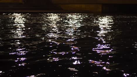 night reflections on water under a bridge