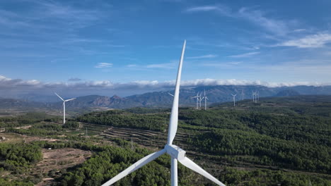 dramatic and stunning view over a wind farm in green mountainous scenery