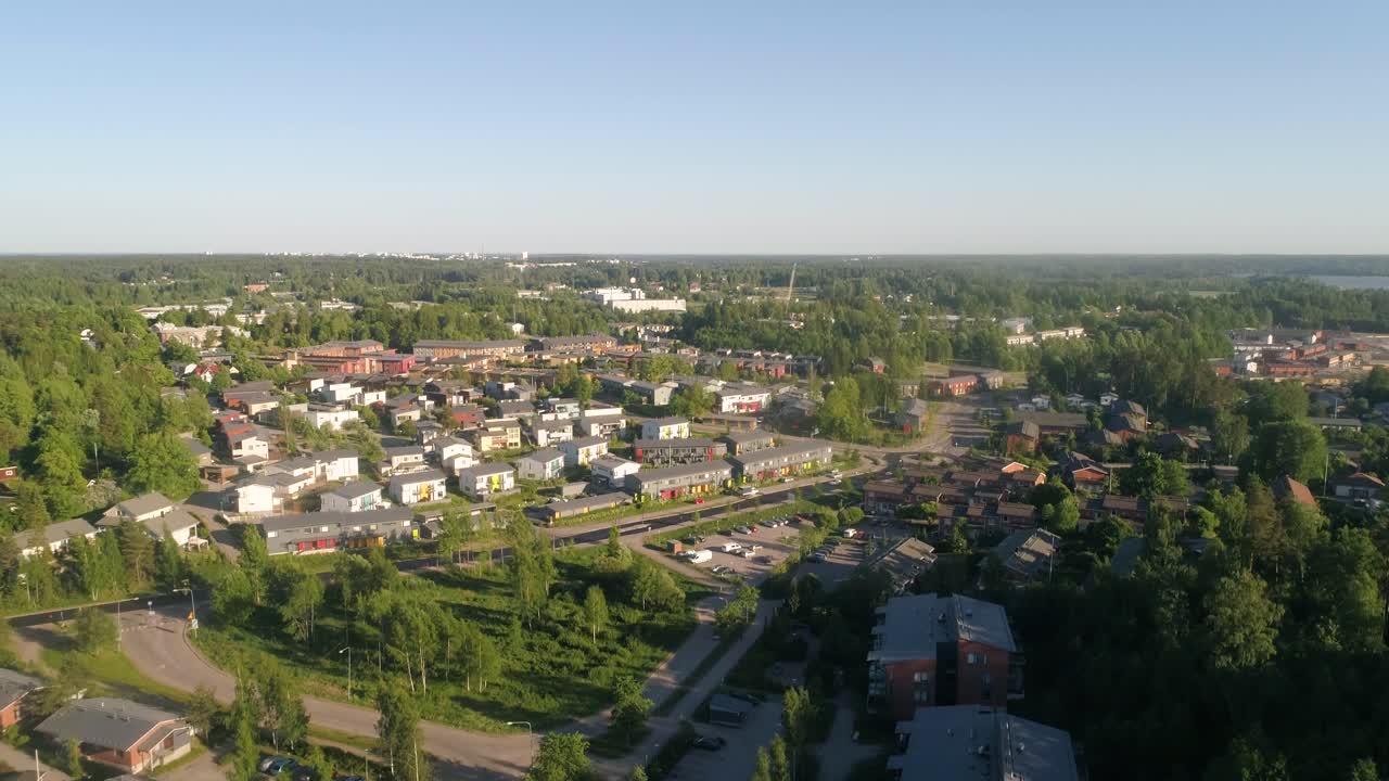 Aerial view overlooking houses and streets, in the Espoo suburbs, sunny, summer day, in Kauklahti, Finland - rising, drone shot