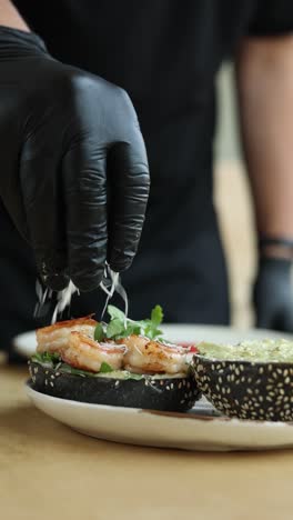 chef preparing a shrimp avocado sandwich