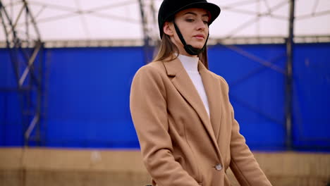 Woman horseback riding in an arena
