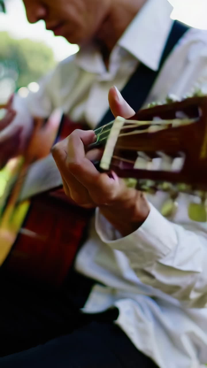 Man Playing Acoustic Guitar in a Garden