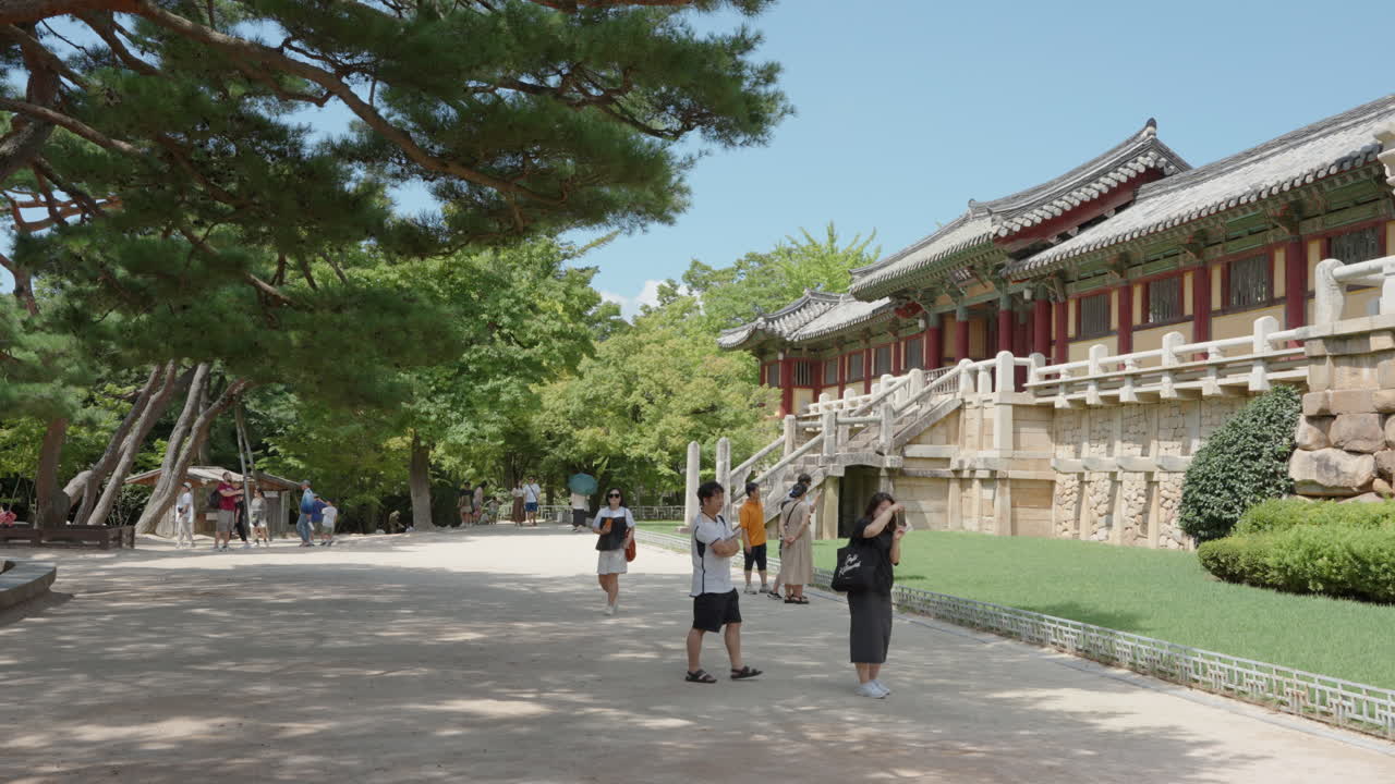 Travelers Admire Old Korean Traditional Palace Architecture at Bulguksa Temple in Gyeongju City in the Summer Daytime