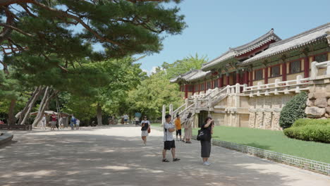 Travelers Admire Old Korean Traditional Palace Architecture at Bulguksa Temple in Gyeongju City in the Summer Daytime