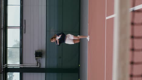 woman playing indoor tennis