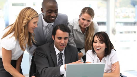 business team looking at a laptop