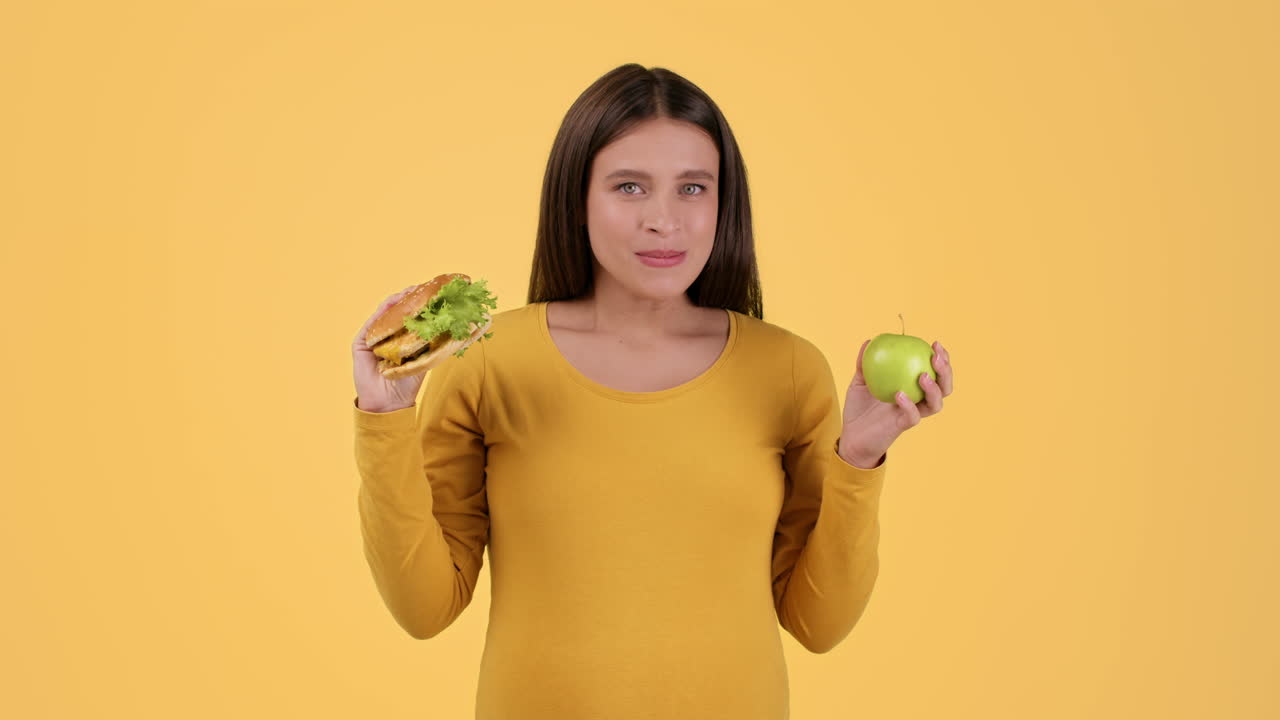 Woman Choosing Between a Hamburger and an Apple