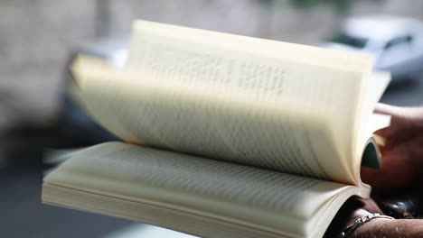 close up of hands quickly flipping through a book