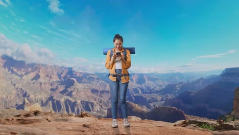 full body of asian female hiker with mountaineering backpack enjoy using smartphone while traveling at the top of mountain