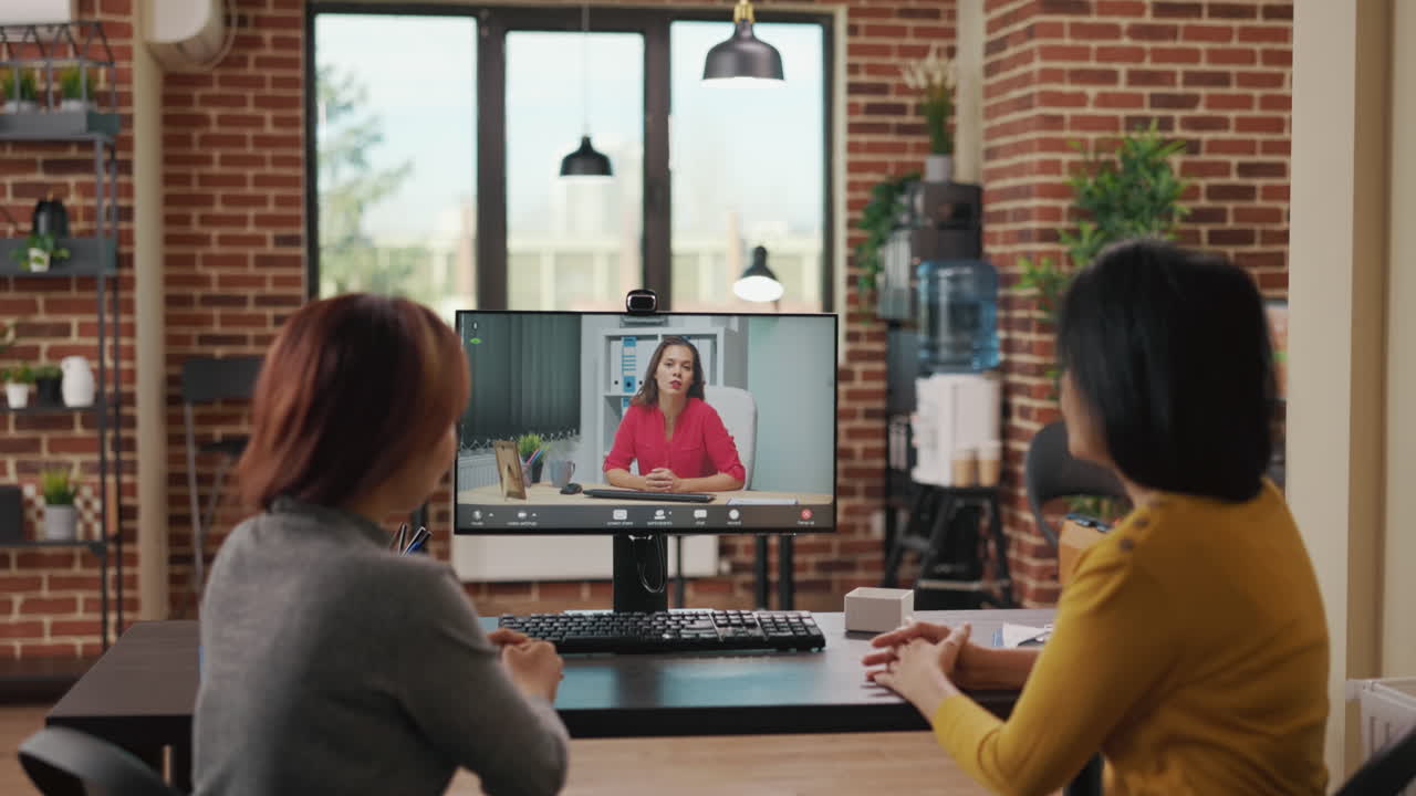 Colleagues using video call conference to recruit woman